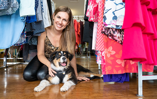 woman and puppy sitting on the floor at an op shop
